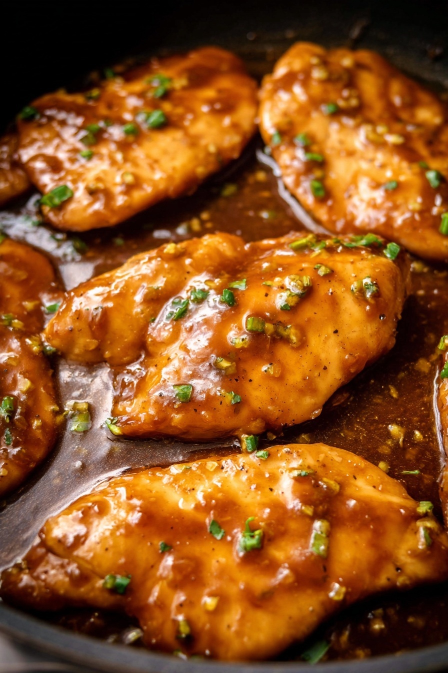 honey garlic chicken - The image shows a plate with three main parts: a white bed of cooked rice with a slight golden tint in some areas, a piece of light-colored cooked chicken on top of the rice covered in a brown glossy sauce with small bits of garlic and chopped green onions, and a bunch of fresh, bright green beans placed to the side. The rice looks light and fluffy, the sauce on the chicken is thick and shiny, and the green beans are crisp and vibrant. The meal is served on a white plate set on a white marbled surface, with a silver fork resting partially in the frame near the bottom right corner. Photo taken with an iphone --ar 2:3 --v 7