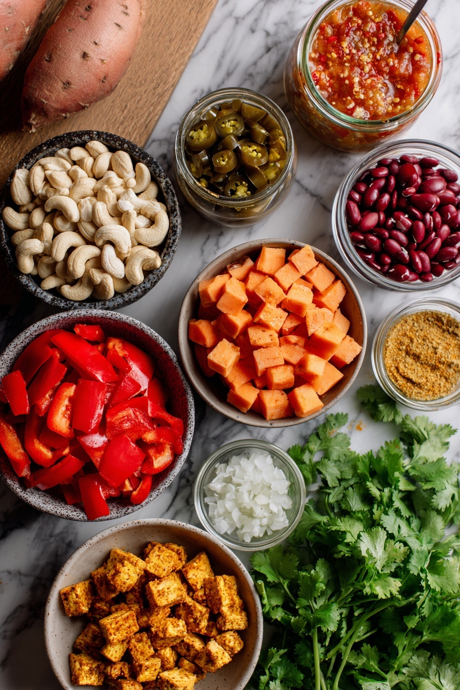 Flat lay of raw cashews, medium chunky salsa, pickled jalapeños with their juice, diced russet and sweet potatoes, red bell pepper, minced garlic, pinto beans, crumbled extra-firm tofu sprinkled with turmeric and nutritional yeast, and fresh cilantro leaves, all beautifully arranged in a colorful and inviting display, placed on a white marble surface, photo taken with an iphone --ar 2:3 --v 7