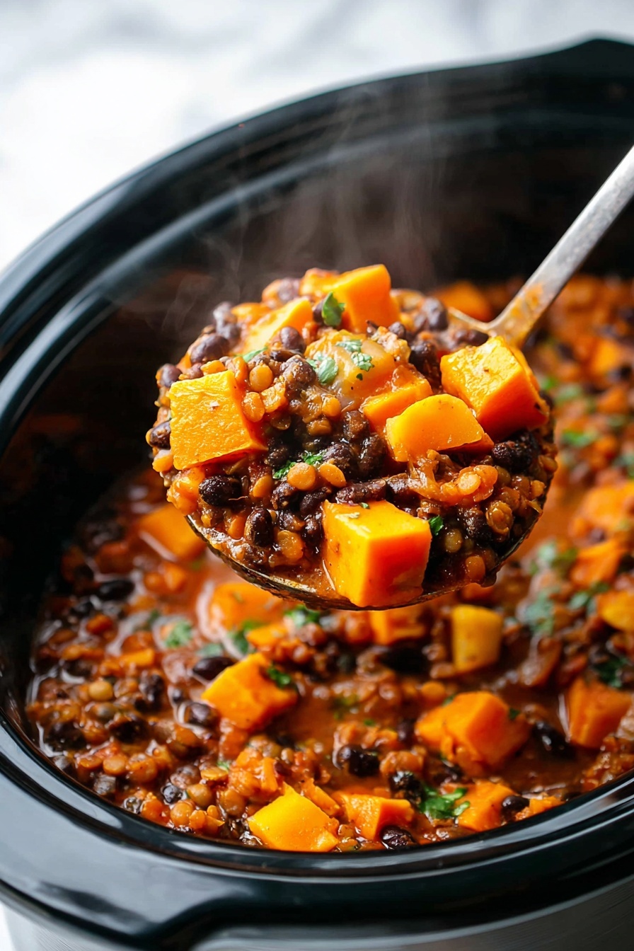 The image shows a close-up of a slow cooker filled with a colorful stew. The stew has three visible layers: the base layer is made of small bright orange cubes of cooked squash giving a firm texture; the middle layer has small black beans scattered throughout; the top layer includes small bits of chopped green herbs sprinkled evenly over the stew. The stew has a thick, reddish-brown sauce that coats all the pieces, giving the whole dish a warm and hearty look. A silver spoon is standing upright in the cooker, partially covered by the ingredients. The background shows a white marbled texture. Photo taken with an iphone --ar 2:3 --v 7