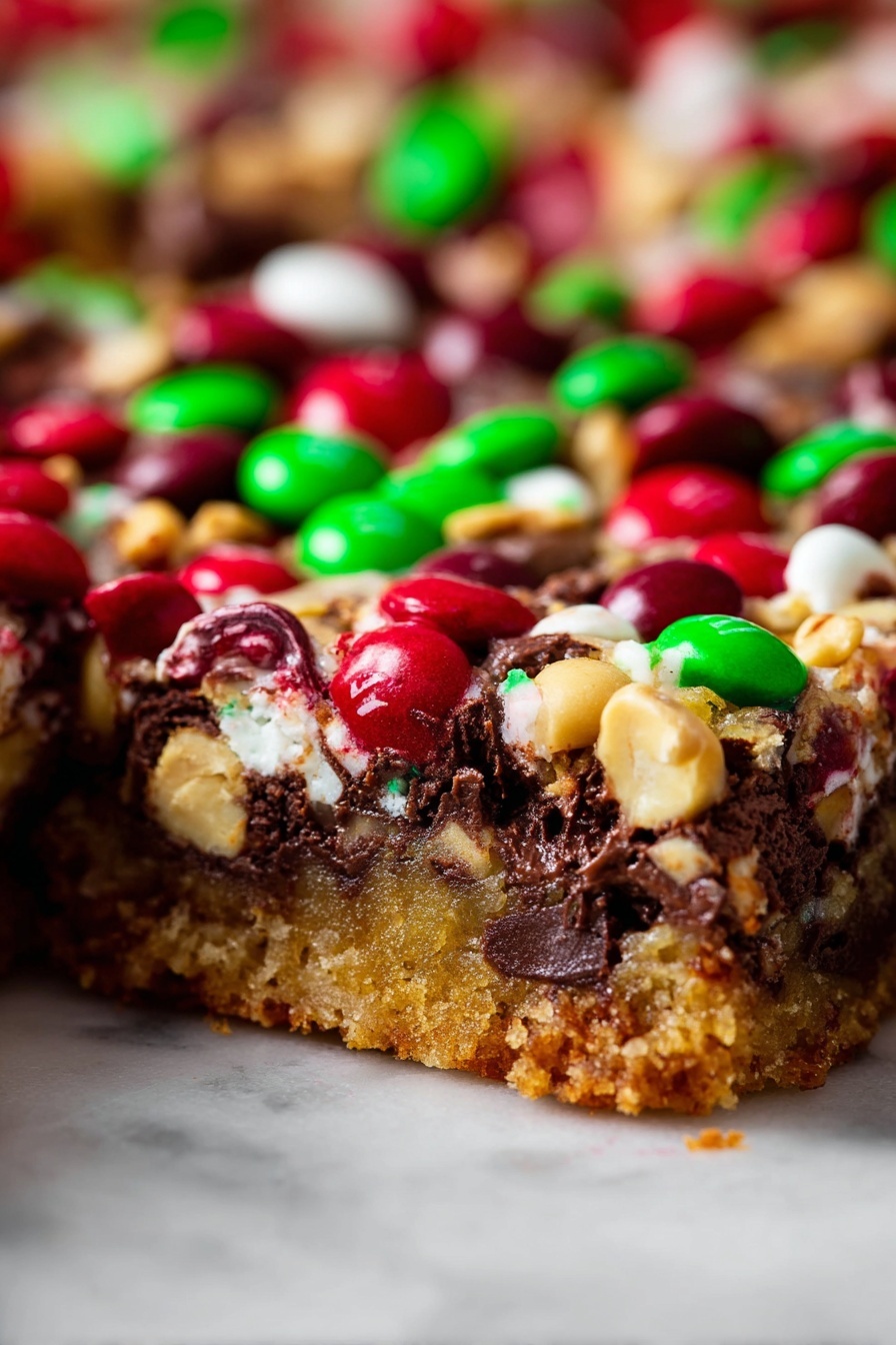 The image shows a close-up view of a thick dessert bar with three main layers visible: the bottom layer is a golden brown crumbly crust, the middle layer is a rich, dark chocolate filling mixed with gooey melted white chocolate swirls, and the top layer is crowded with colorful red and green candy-coated chocolates along with light tan nuts scattered evenly across the surface. The dessert appears moist and dense, with vibrant colors of red, green, white, and brown standing out sharply against a white marbled textured background. Photo taken with an iphone --ar 2:3 --v 7