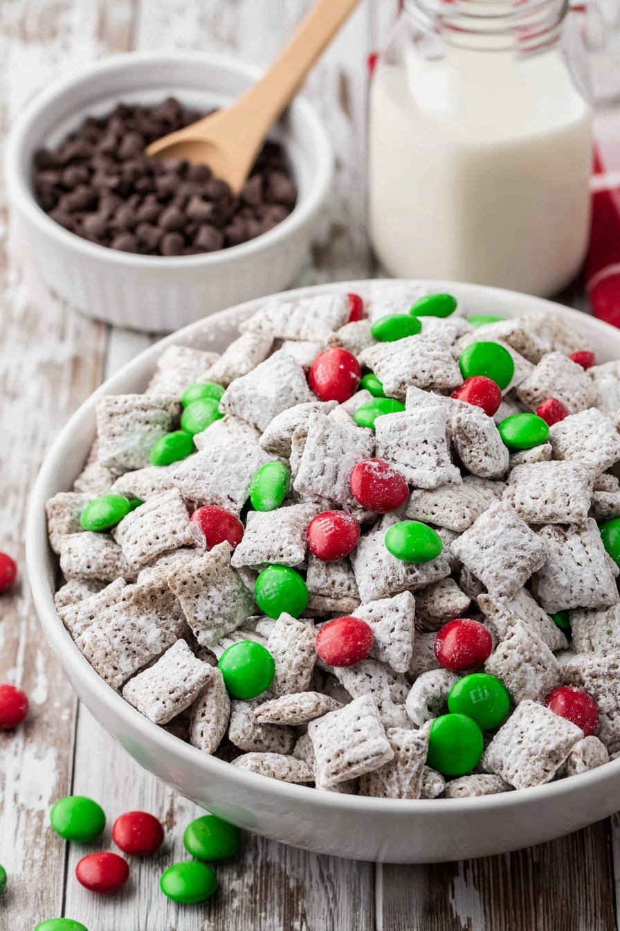 A large white bowl is filled with many small, square cereal pieces coated in white powder, giving them a snowy look. Scattered evenly on top and around the cereal are bright red and green candy-coated chocolates, adding colorful spots to the white base. To the right, a smaller white bowl holds more of these red and green chocolates, with some spilling out onto the wood-textured table. At the bottom, a small light wooden scoop is filled with the same red and green candies. A green cloth with white dots lies on the left side under the bowl, and the whole scene rests on a wooden table with light brown grain lines. photo taken with an iphone --ar 2:3 --v 7