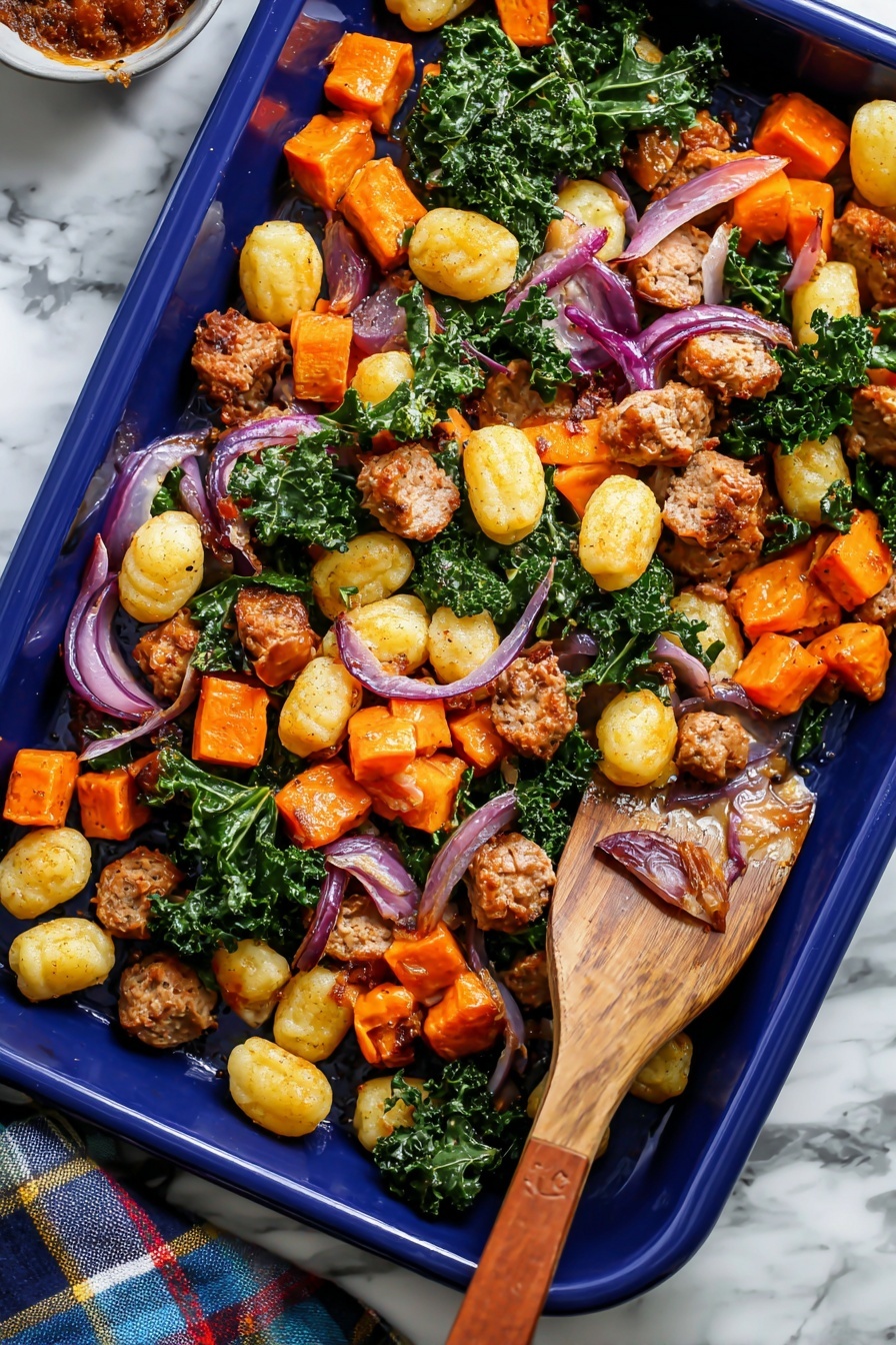The image shows a blue baking tray filled with a mix of cooked food. There are three main layers: the first layer is small, round, golden gnocchi scattered all over; the second layer is bright orange cubes of roasted sweet potatoes and pieces of browned sausage; the third layer consists of wilted green kale leaves and strips of cooked red onion spread unevenly among the other ingredients. A wooden spatula with a brown handle is placed in the tray, lifting some of the food on the right side. The tray is set against a white marbled surface, and there is a plaid cloth partially visible on the lower left side of the image. photo taken with an iphone --ar 2:3 --v 7