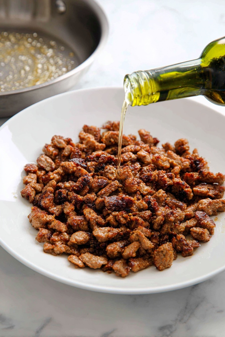 A white bowl filled with a colorful stir-fry noodle dish that has three main layers: long, light brown noodles spread throughout; medium-sized pieces of dark brown cooked meat placed evenly on top and within the noodles; and mixed vegetables including green broccoli florets, thin orange carrot sticks, red bell pepper chunks, white onion pieces, and small bright green chopped scallions sprinkled over everything. The bowl sits on a white marbled surface with a soft white cloth in the background. The lighting is bright, highlighting the shiny texture of the sauce coating the noodles and ingredients. photo taken with an iphone --ar 2:3 --v 7