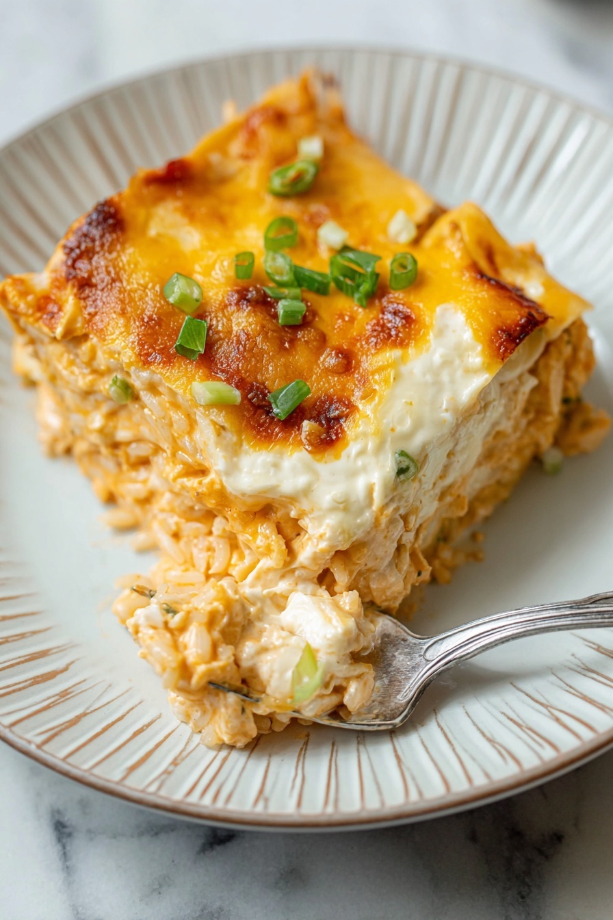 The image shows a white rectangular baking dish with the bottom layer made of a smooth, light orange mixture. On top, there are chunks of cooked orange-colored pieces mixed with small green bits, spread evenly across the dish. A creamy, pale white sauce is being poured from a large spoon over the orange pieces, creating wavy lines of sauce across the dish. In the background, there is a clear glass bowl containing the orange mixture with green bits, and a wooden spoon resting inside. The setting is on a white marbled surface photo taken with an iphone --ar 2:3 --v 7