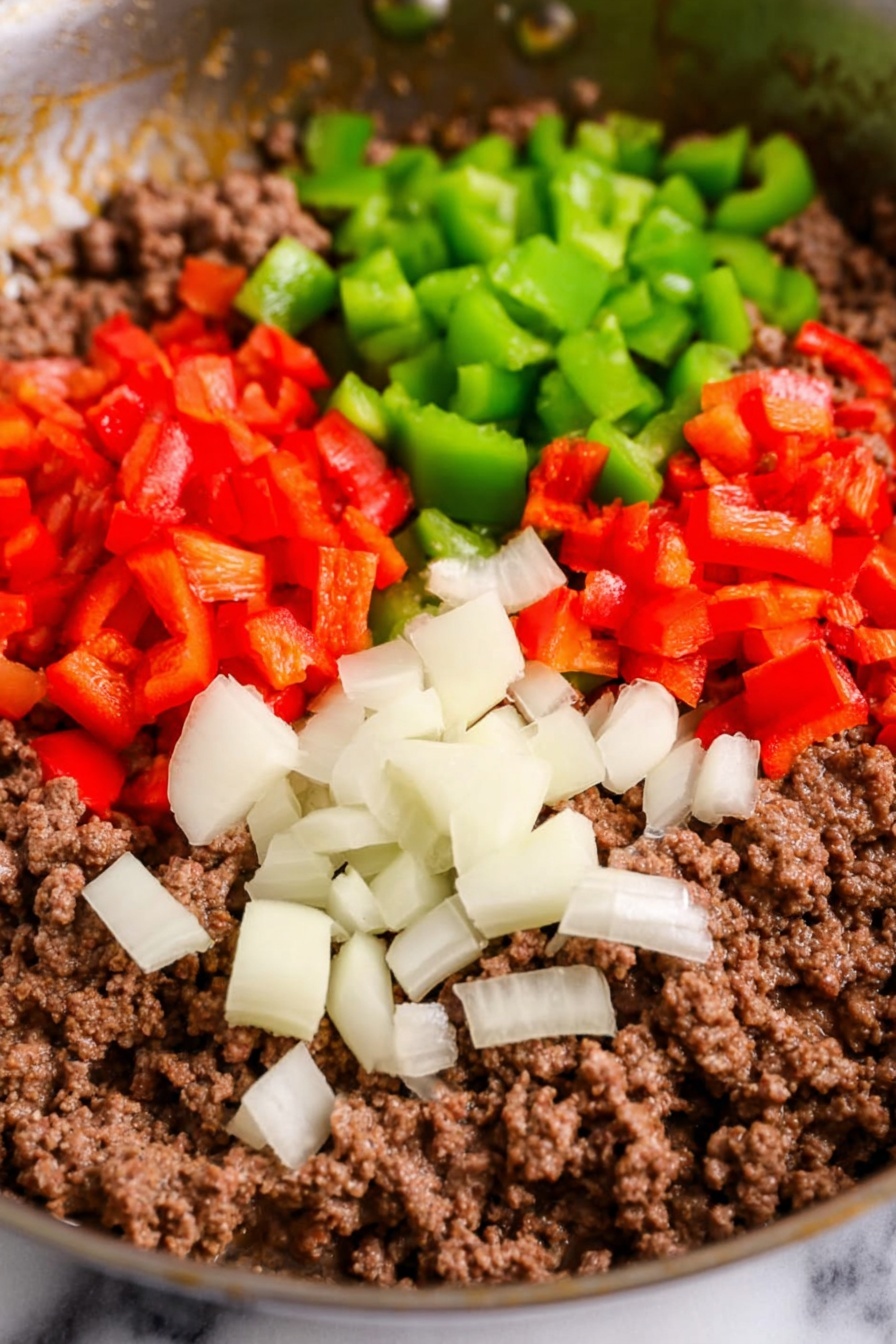 A white bowl filled with a layered casserole dish. The bottom layer shows creamy, sliced potatoes with a smooth texture, slightly yellowish-white. On top, there is a mix of ground meat in small chunks with a light brown color, mixed with finely chopped red and green peppers. The top layer is covered with melted cheese that has golden and orange patches from baking, showing some browned, bubbly spots. Small green herb bits are sprinkled across the dish. A metal spoon rests inside the bowl, scooping some of the casserole. The bowl sits on a white marbled surface next to a black and white striped cloth. Photo taken with an iphone --ar 2:3 --v 7